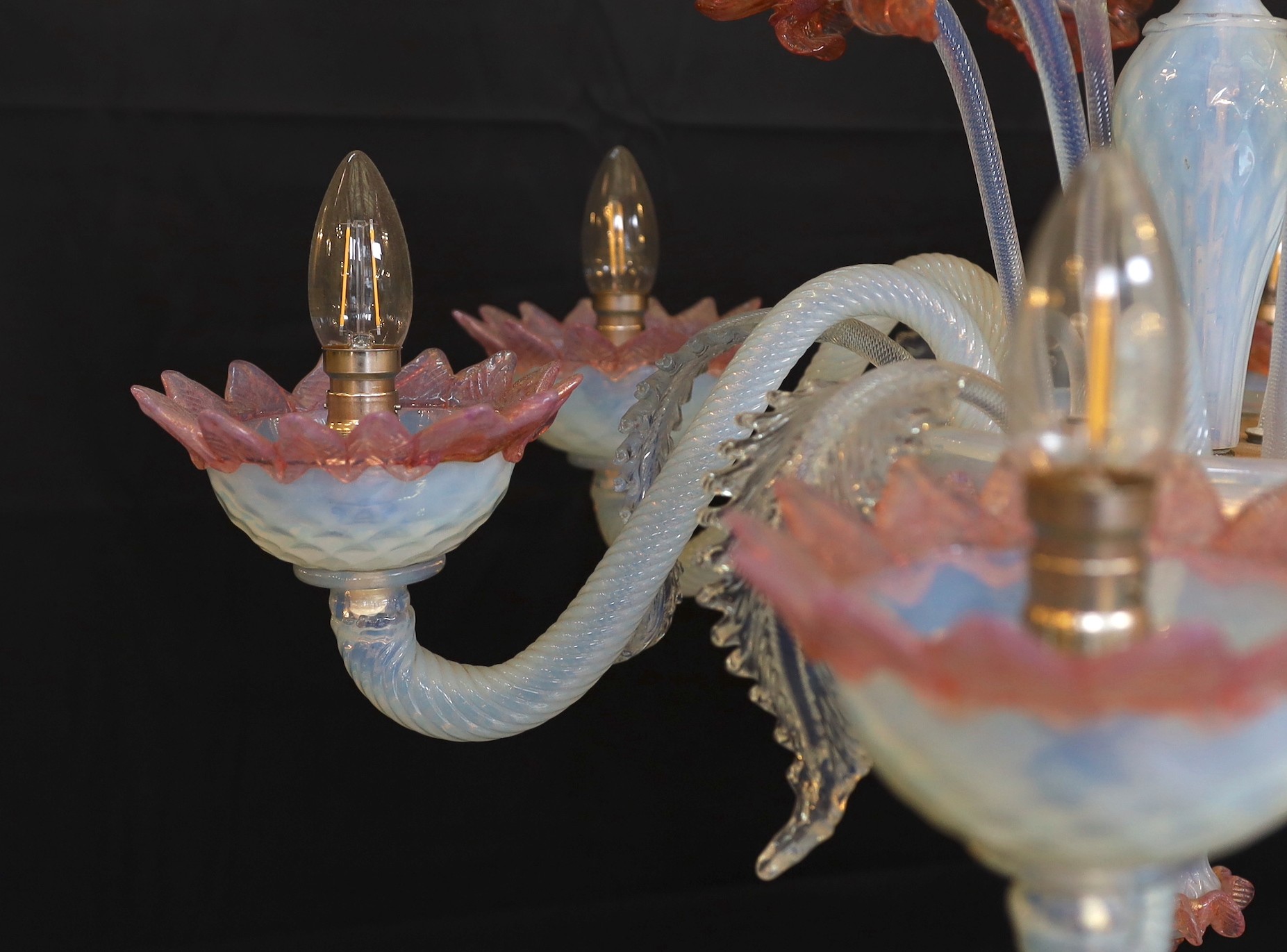 A 1950s Venetian pink and Vaseline glass six light chandelier with ornate flower and leaf motifs, height 90cm. width 70cm
